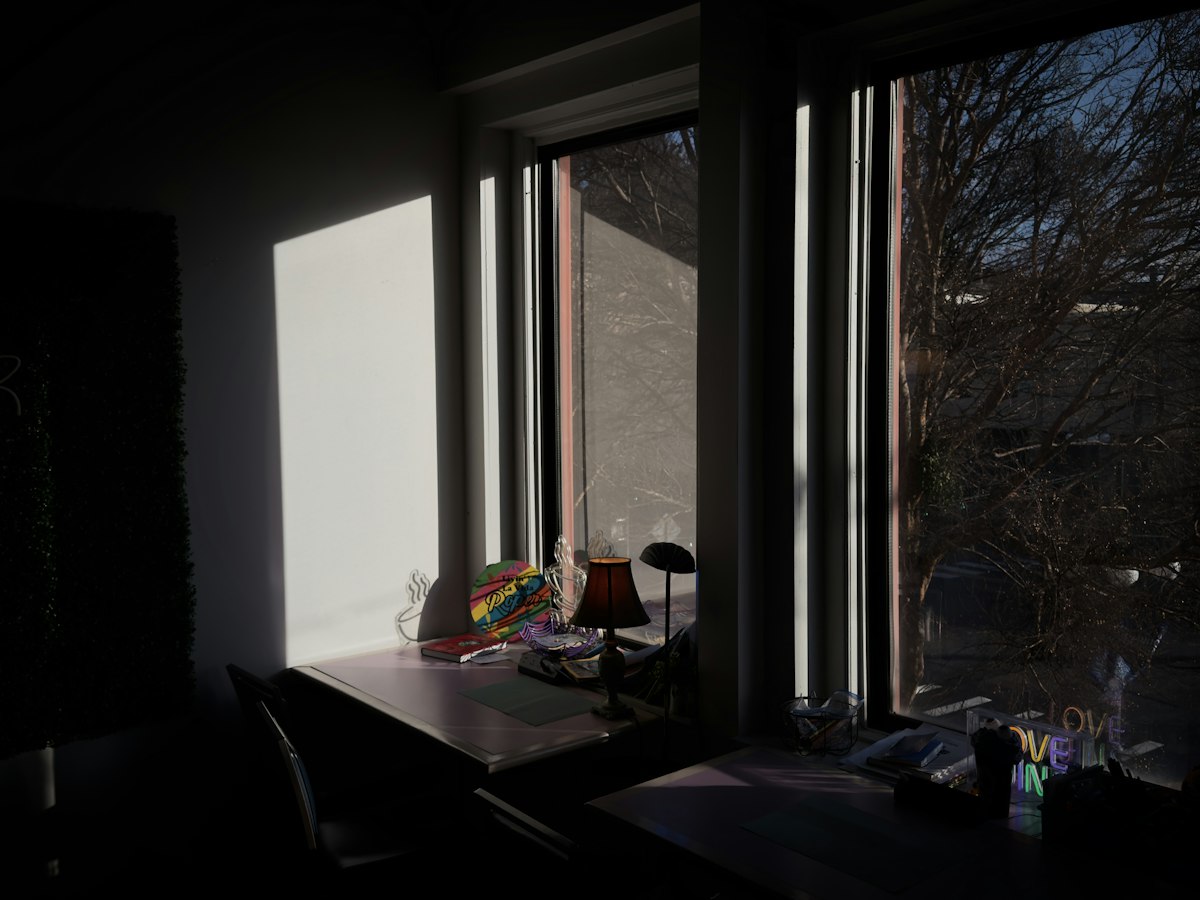 Sunlight streaming through a window onto a desk