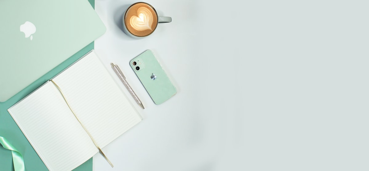 A white ceramic mug on a bright white table, suggesting a calm space for daily writing