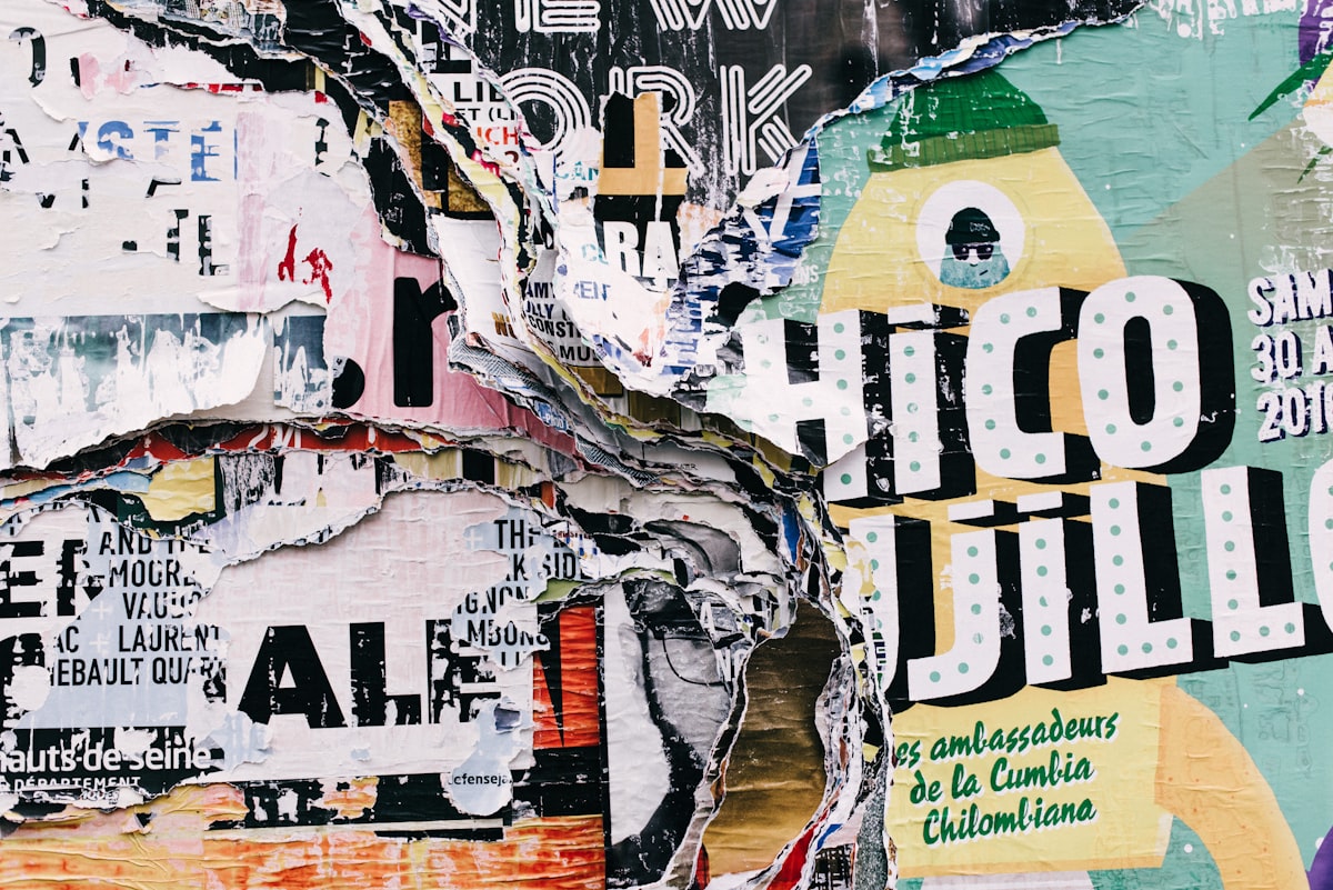 An open journal page layered with torn paper, a photograph, and handwritten text, used as a collage journaling example