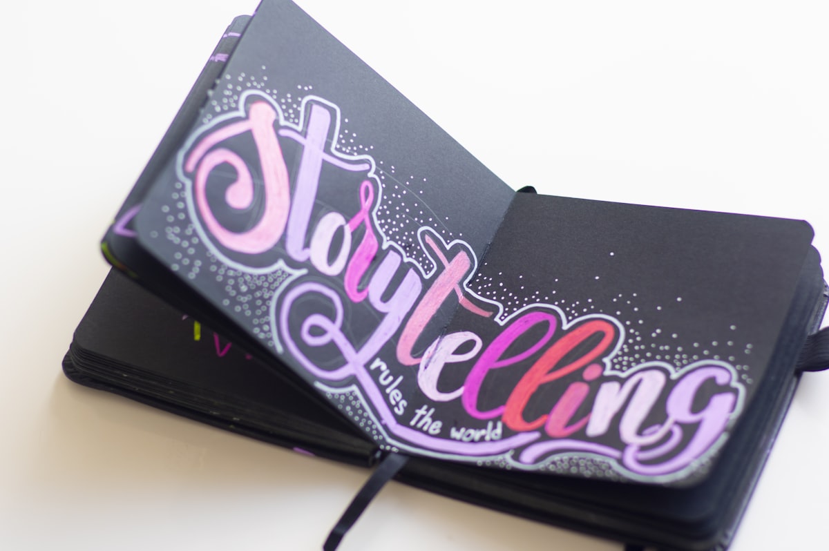 An open personal diary with hand-drawn doodles, decorative lettering, and handwritten entries on a wooden desk