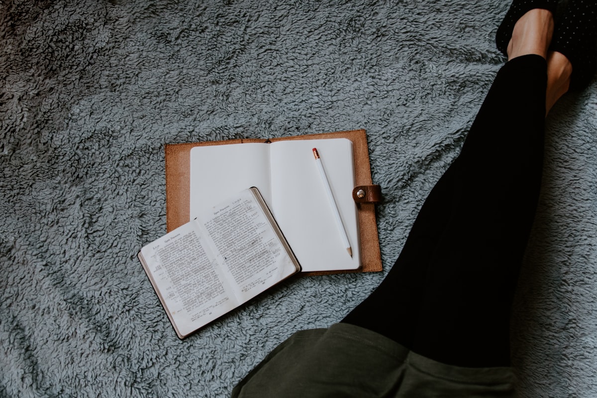 An open notebook resting on a calm surface, ready for emotional reflection writing