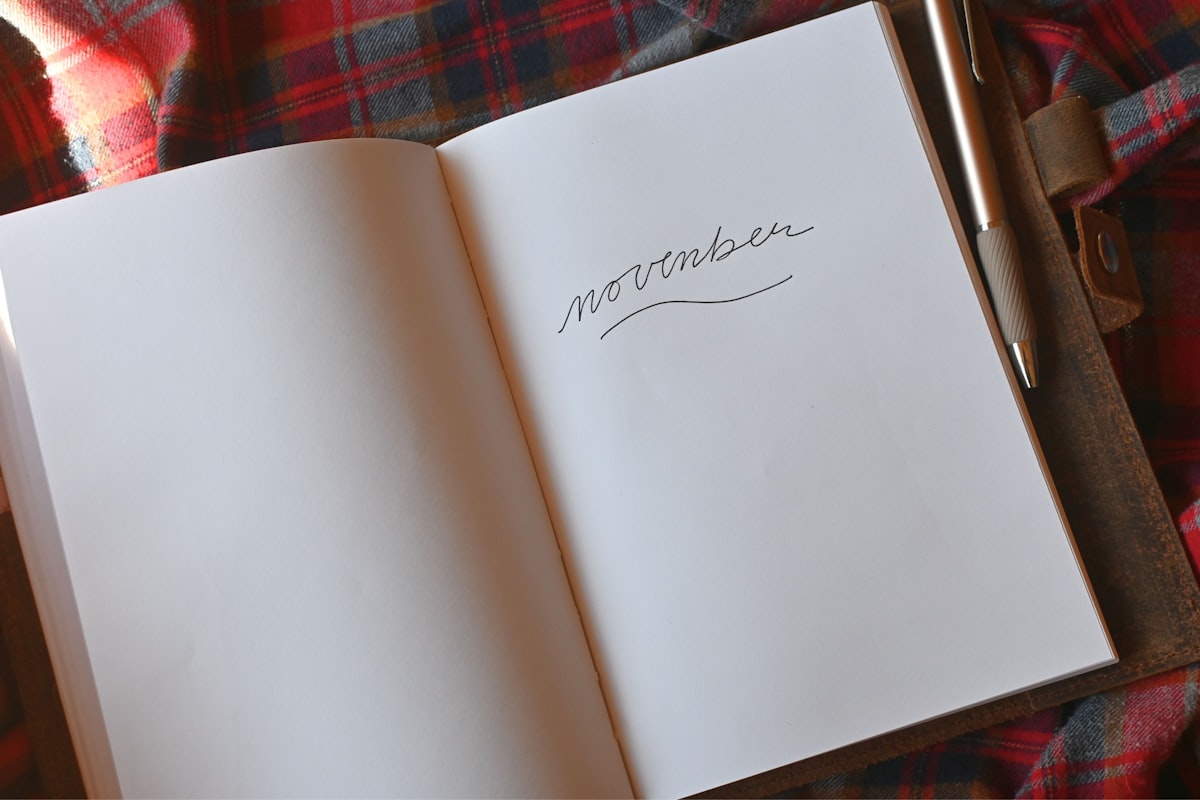An open notebook with a pen resting on top, ready for a brief gratitude entry