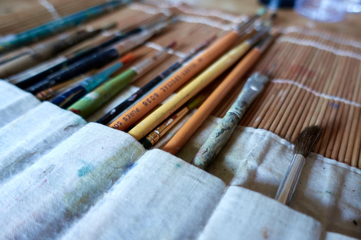 Brown and green colored pencils arranged together, suggesting an artist's working tools