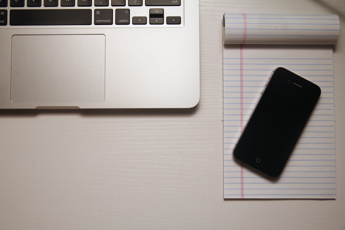 A phone lying face down on a sheet of ruled paper
