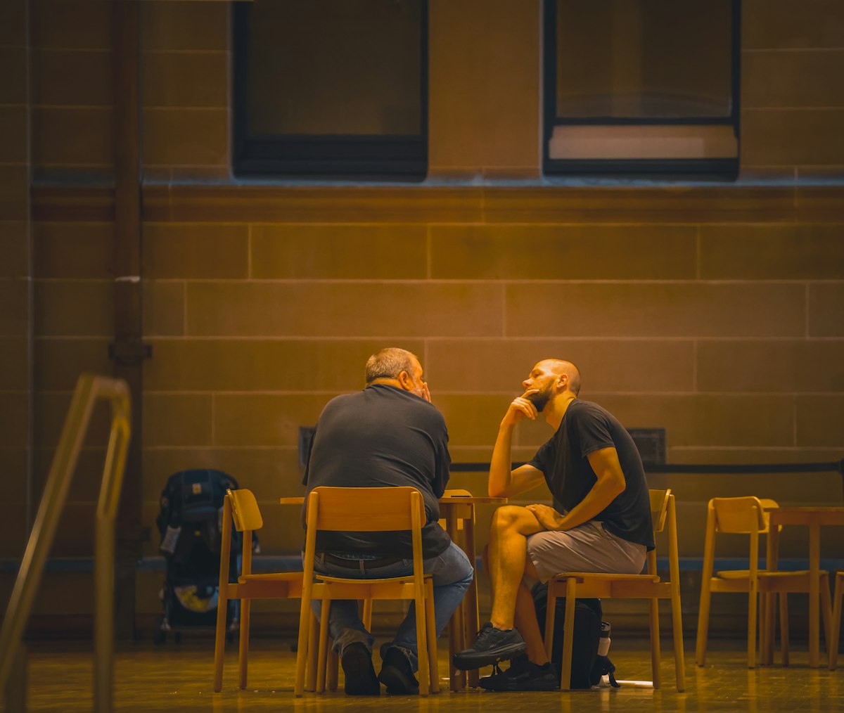 Two people sitting at a table in close conversation, suggesting honest connection