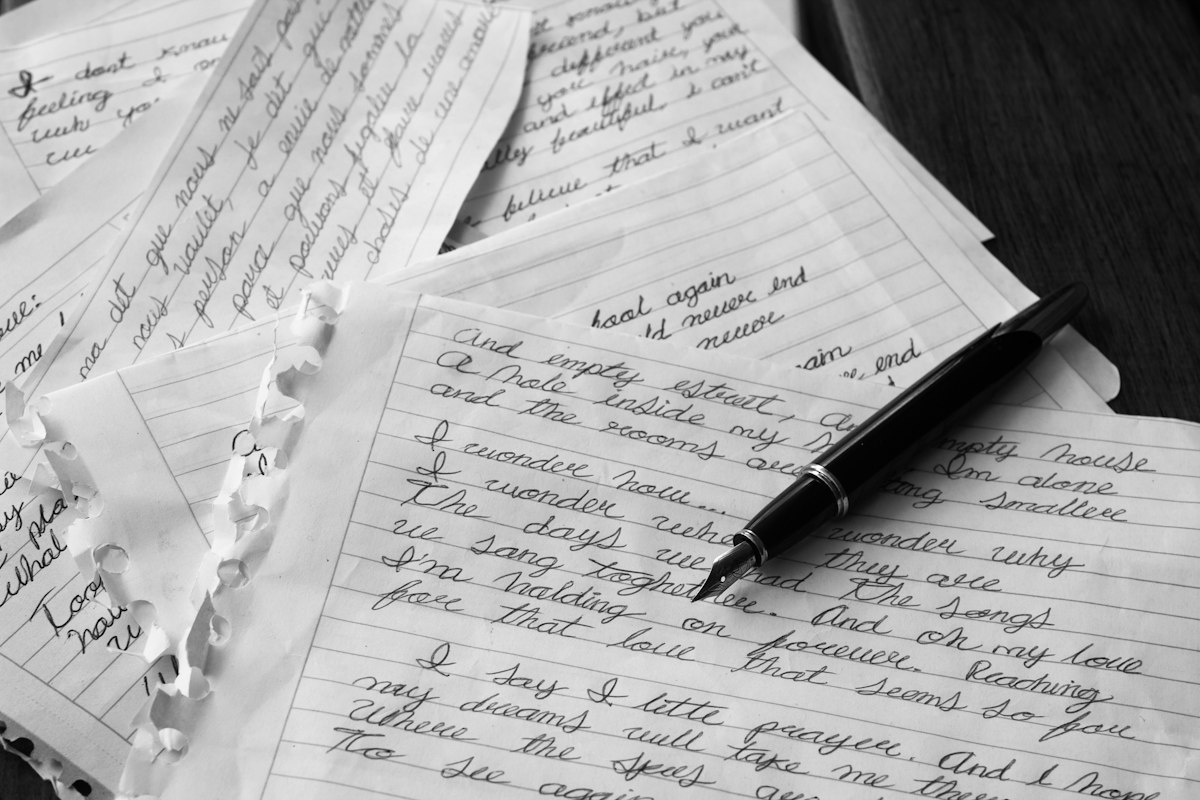 A black pen resting on a sheet of white paper